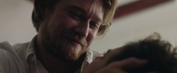 Movie still from “Stars at Noon” (2022), directed by Claire Denis – A person using a cell phone; Close Up shot, Over the shoulder angle