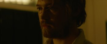 Movie still from “Stars at Noon” (2022), directed by Claire Denis – A person with a beard; Close Up shot, Over the shoulder angle