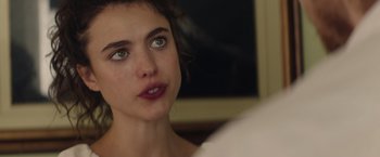 Movie still from “Stars at Noon” (2022), directed by Claire Denis – A person looking at the camera; Close Up shot, Over the shoulder angle