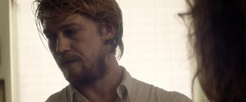 Movie still from “Stars at Noon” (2022), directed by Claire Denis – A person with a beard; Close Up shot, Over the shoulder angle