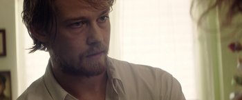 Movie still from “Stars at Noon” (2022), directed by Claire Denis – A person with a beard; Close Up shot, Over the shoulder angle