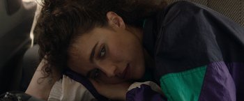 Movie still from “Stars at Noon” (2022), directed by Claire Denis – A person laying on the ground; Close Up shot, High angle