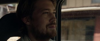 Movie still from “Stars at Noon” (2022), directed by Claire Denis – A person looking out a window; Close Up shot, Over the shoulder angle