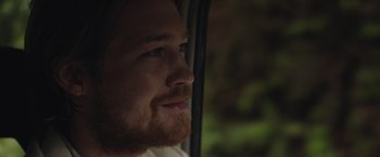 Movie still from “Stars at Noon” (2022), directed by Claire Denis – A person looking out a window; Close Up shot, Over the shoulder angle