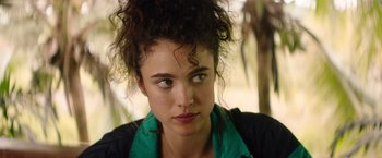 Movie still from “Stars at Noon” (2022), directed by Claire Denis – A person wearing a jacket; Close Up shot, Over the shoulder angle