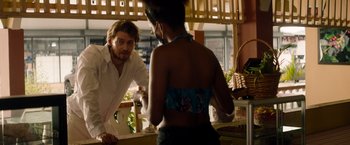 Movie still from “Stars at Noon” (2022), directed by Claire Denis – A man and a woman are looking at each other in the mirror; Medium shot, Over the shoulder angle