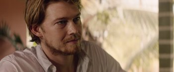 Movie still from “Stars at Noon” (2022), directed by Claire Denis – A person with a beard; Close Up shot, Over the shoulder angle