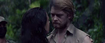 Movie still from “Stars at Noon” (2022), directed by Claire Denis – A man and a woman face to face in a forest; Close Up shot, Over the shoulder angle