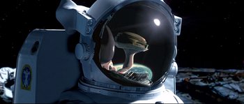 Movie still from “Austin Powers: The Spy Who Shagged Me” (1999), directed by Jay Roach – An image of an astronaut in a space suit looking out of a space ship window; Close Up shot, Overhead angle