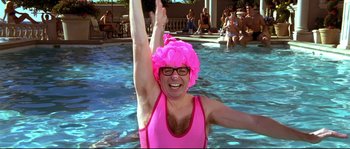 Movie still from “Austin Powers: The Spy Who Shagged Me” (1999), directed by Jay Roach – A woman in a pink bathing suit and a pink wig; Medium shot, Overhead angle