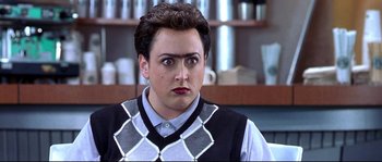 Movie still from “Austin Powers: The Spy Who Shagged Me” (1999), directed by Jay Roach – A man in a black and white sweater looking at the camera; Close Up shot, Over the shoulder angle