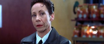 Movie still from “Austin Powers: The Spy Who Shagged Me” (1999), directed by Jay Roach – A woman in a black jacket and a white shirt; Close Up shot, Low angle