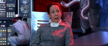 Movie still from “Austin Powers: The Spy Who Shagged Me” (1999), directed by Jay Roach – A woman sitting in a chair with a clown on her face; Close Up shot, High angle