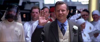 Movie still from “Austin Powers: The Spy Who Shagged Me” (1999), directed by Jay Roach – A man in a suit and tie holding up his hand; Close Up shot, Low angle