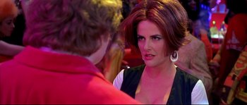 Movie still from “Austin Powers: The Spy Who Shagged Me” (1999), directed by Jay Roach – A woman is talking to another woman at a party; Close Up shot, Over the shoulder angle