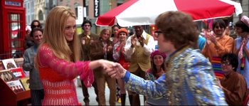 Movie still from “Austin Powers: The Spy Who Shagged Me” (1999), directed by Jay Roach – A group of young people dressed up in costumes; Medium shot, Over the shoulder angle