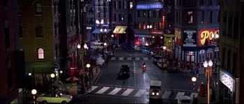 Movie still from “Austin Powers: The Spy Who Shagged Me” (1999), directed by Jay Roach – A street scene with cars and motorcycles at night; Extreme Wide shot, High angle