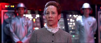 Movie still from “Austin Powers: The Spy Who Shagged Me” (1999), directed by Jay Roach – An older woman is wearing a gray jacket; Close Up shot, Low angle