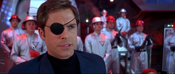 Movie still from “Austin Powers: The Spy Who Shagged Me” (1999), directed by Jay Roach – A person wearing a eye patch; Close Up shot, Over the shoulder angle