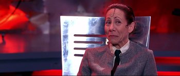 Movie still from “Austin Powers: The Spy Who Shagged Me” (1999), directed by Jay Roach – A woman in a suit and a tie; Close Up shot, Low angle