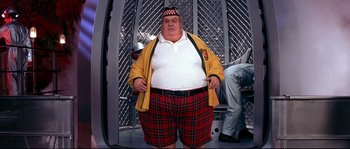 Movie still from “Austin Powers: The Spy Who Shagged Me” (1999), directed by Jay Roach – A man in plaid shorts and a yellow jacket; Medium shot, Low angle