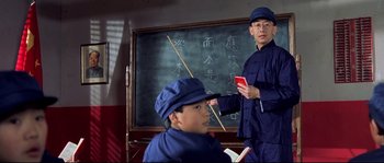 Movie still from “Austin Powers: The Spy Who Shagged Me” (1999), directed by Jay Roach – A man and a boy in front of a chalkboard; Medium shot, Low angle
