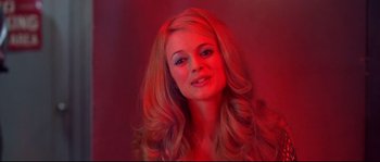 Movie still from “Austin Powers: The Spy Who Shagged Me” (1999), directed by Jay Roach – A woman with long blonde hair in a red room; Close Up shot, Low angle