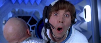 Movie still from “Austin Powers: The Spy Who Shagged Me” (1999), directed by Jay Roach – A man in a space suit is looking surprised; Close Up shot, Overhead angle