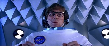 Movie still from “Austin Powers: The Spy Who Shagged Me” (1999), directed by Jay Roach – A man in a spacesuit with a helmet on his head; Medium shot, Overhead angle