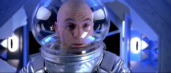 Movie still from “Austin Powers: The Spy Who Shagged Me” (1999), directed by Jay Roach – A man in a space suit in a space helmet; Close Up shot, Low angle