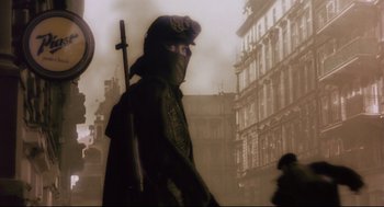 Movie still from “Avalon” (2001), directed by Mamoru Oshii – A man with a helmet on walking in the fog; Close Up shot, Low angle
