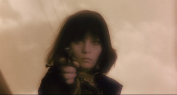 Movie still from “Avalon” (2001), directed by Mamoru Oshii – A woman is holding a gun in her hand; Close Up shot, Low angle