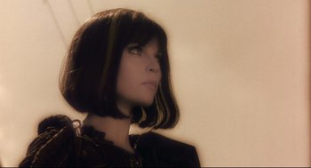 Movie still from “Avalon” (2001), directed by Mamoru Oshii – A woman with short black hair is looking to her left; Close Up shot, Low angle
