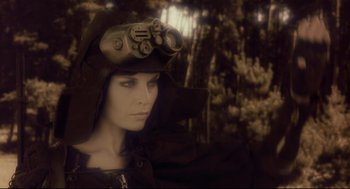 Movie still from “Avalon” (2001), directed by Mamoru Oshii – A woman wearing a hat and holding a binocular; Close Up shot, Low angle