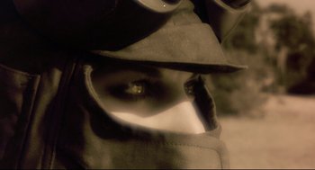 Movie still from “Avalon” (2001), directed by Mamoru Oshii – A person's eye with a hat on; Extreme Close Up shot, Overhead angle