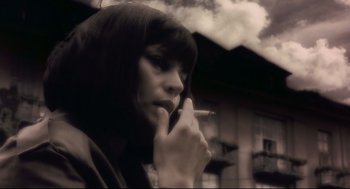 Movie still from “Avalon” (2001), directed by Mamoru Oshii – A woman smoking a cigarette while talking on a cell phone; Close Up shot, Low angle