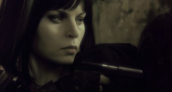Movie still from “Avalon” (2001), directed by Mamoru Oshii – A woman holding a gun in her hand; Close Up shot, Low angle