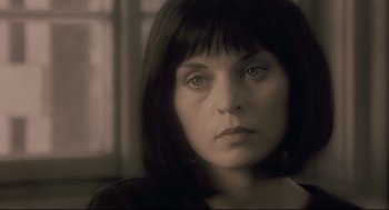 Movie still from “Avalon” (2001), directed by Mamoru Oshii – A person with short black hair; Close Up shot, Over the shoulder angle