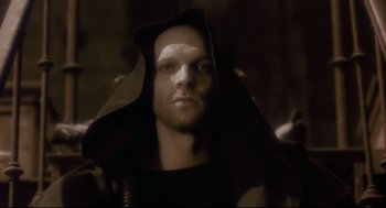 Movie still from “Avalon” (2001), directed by Mamoru Oshii – A person wearing a hood; Close Up shot, Low angle