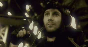 Movie still from “Avalon” (2001), directed by Mamoru Oshii – A person with a helmet on; Close Up shot, Low angle