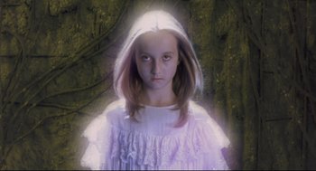 Movie still from “Avalon” (2001), directed by Mamoru Oshii – A young girl in a white dress and a white hood; Close Up shot, Low angle