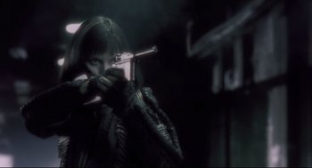 Movie still from “Avalon” (2001), directed by Mamoru Oshii – A woman is holding a gun in a dark room; Close Up shot, Low angle