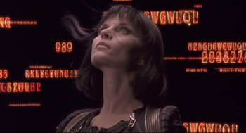 Movie still from “Avalon” (2001), directed by Mamoru Oshii – A woman is looking up into the air; Close Up shot, Low angle