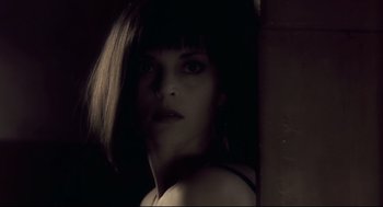 Movie still from “Avalon” (2001), directed by Mamoru Oshii – A person with short black hair; Close Up shot, Low angle