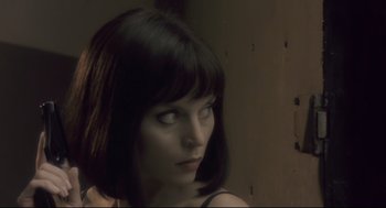Movie still from “Avalon” (2001), directed by Mamoru Oshii – A person with short black hair; Close Up shot, Over the shoulder angle