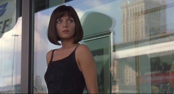 Movie still from “Avalon” (2001), directed by Mamoru Oshii – A woman standing in front of a window; Close Up shot, Over the shoulder angle