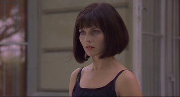 Movie still from “Avalon” (2001), directed by Mamoru Oshii – A woman in a black top with a short haircut; Close Up shot, Low angle