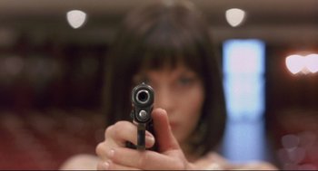 Movie still from “Avalon” (2001), directed by Mamoru Oshii – A woman holding a gun in front of a mirror; Extreme Close Up shot, Overhead angle