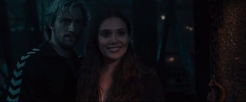Movie still from “Avengers: Age of Ultron” (2015), directed by Joss Whedon – A young woman smiles while standing next to a young man; Close Up shot, Over the shoulder angle