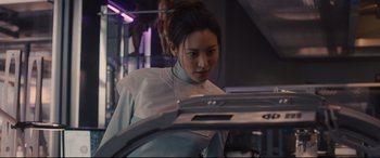 Movie still from “Avengers: Age of Ultron” (2015), directed by Joss Whedon – A woman in white shirt looking down at camera; Medium shot, Low angle